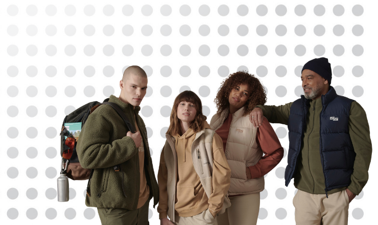 A group of adults model the Stanley/Stella AW24 range, against a grey-spotted background