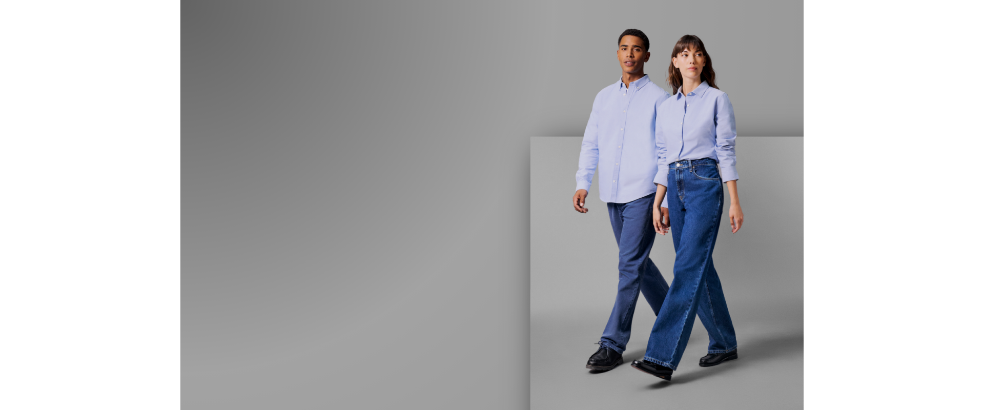 Two models wear StanleyStella shirts on a grey background