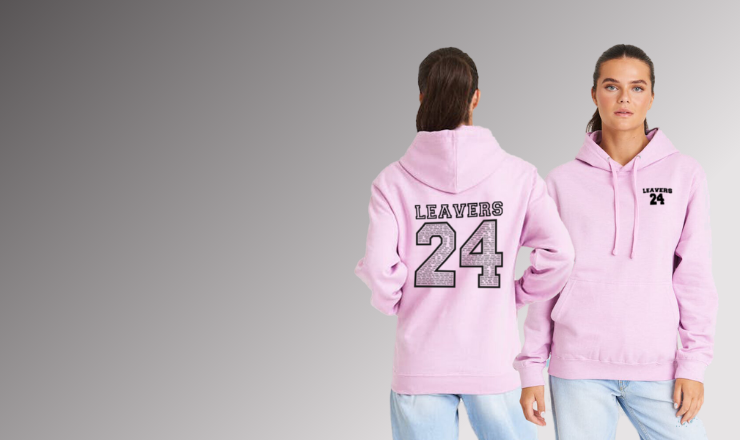 Young adult models a 2024 Leaver's Hoodie against a grey background